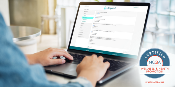 Man taking a health assessment on a laptop displaying the NCQA Certification Seal